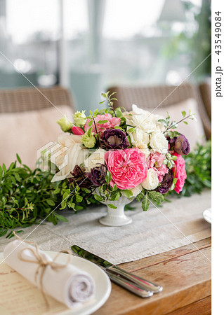 Neatly twisted into a tube dining room napkin decorated with a sprig of pistachio. Wedding Banquet 43549084