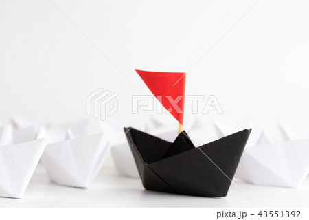 Black paper ship lead among white Black paper ship lead among white 43551392