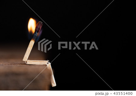 Burning match human sitting on wooden table 43551400