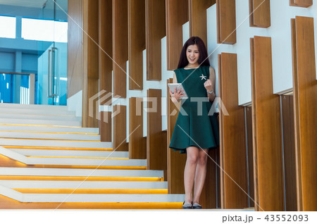 Asian Businesswomen using the tablet with cheerful action on the staircase In the modern creative Office, business success concept 43552093