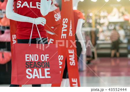 Part of male mannequin dressed in casual clothes holding the Sales paper shopping bag in the shopping department store for shopping, business fashion and advertisement concept 43552444