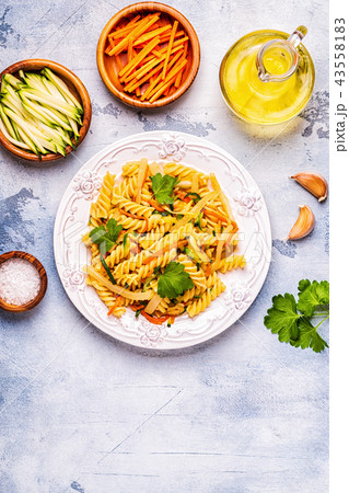 Fusilli pasta with squid, zucchini and carrots Fusilli pasta with squid, zucchini and carrots 43558183