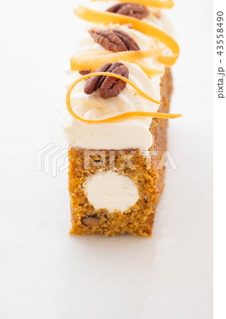 Carrot cake pie, sprinkled with nuts, decorated with cream-colored carrots on white marble. Carrot cake pie, sprinkled with nuts, decorated with cream-colored carrots on white marble. 43558490