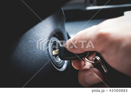 turning car key to start the car engine 43560883