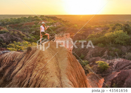 Young woman standing on top of the hill,  43561656