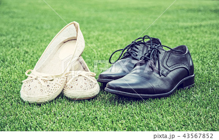 Women's and men's wedding shoes on grass 43567852