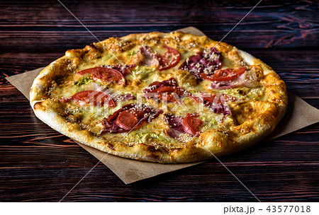 Pizza with a bottle of beer on a wooden table 43577018