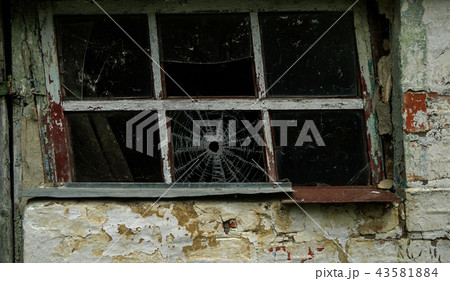 Broken glass in a old window frame Broken glass in a old window frame 43581884