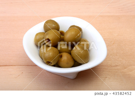 Bowl with fresh olives on wooden background. 43582452