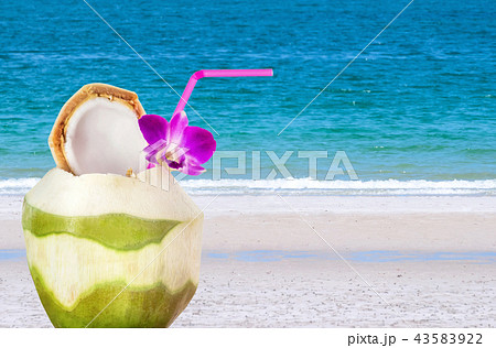 Green coconuts with drinking straw  43583922