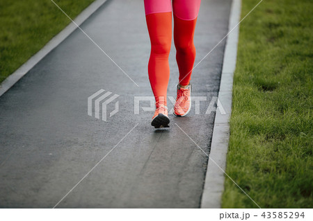 woman runner in crimson leggings 43585294