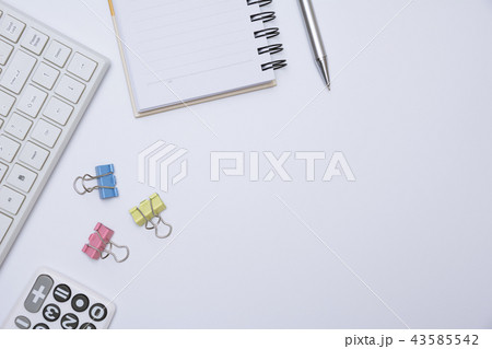 Top view of office supplies and notebook on white 43585542
