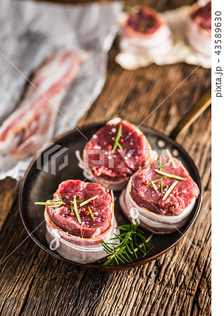 Beef tenderloin steak wrapped in bacon . 43589630