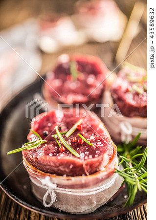 Beef tenderloin steak wrapped in bacon. 43589632