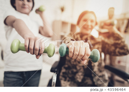 Disabled Woman Dumpbells Exercises With A Son. Disabled Woman Dumpbells Exercises With A Son. 43596464