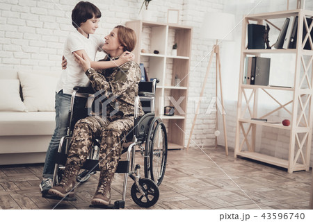 Woman Veteran In Wheelchair Homecoming Concept. Woman Veteran In Wheelchair Homecoming Concept. 43596740