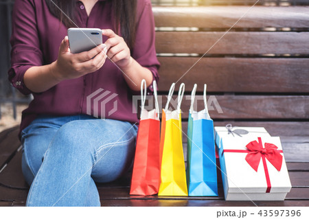 Consumerism, shopping, lifestyle concept, Young woman sitting ne 43597396