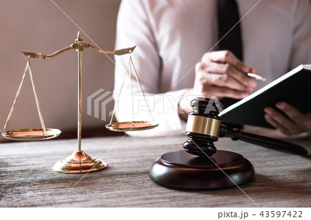 Gavel on wooden table and Lawyer or Judge working with agreement Gavel on wooden table and Lawyer or Judge working with agreement 43597422
