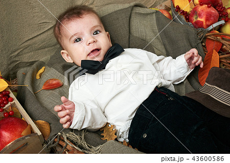 autumn concept - child boy lie on yellow leaves autumn concept - child boy lie on yellow leaves 43600586
