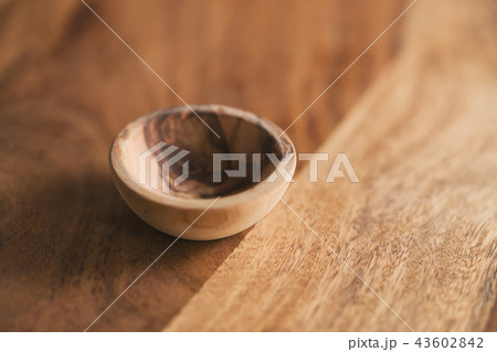 small wooden bowl on wood table 43602842