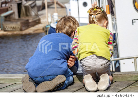 Brother and sister enjoying their vacation in the harbour 43604247