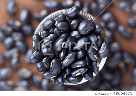 Black bean in glass cups on wooden close up 43604679
