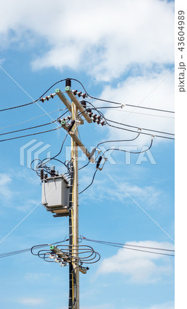 Electric pole and transformer on a blue sky. 43604989
