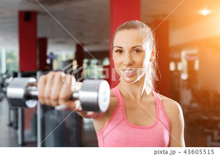 fitness coach with a dumbbell 43605515