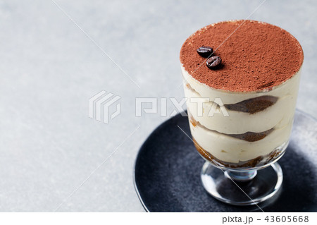 Tiramisu, traditional Italian dessert in glass on a grey stone background. Copy space. 43605668