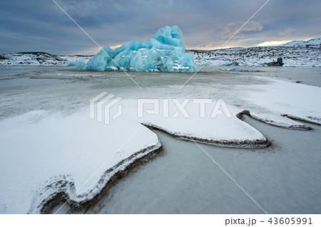 Famous Fjallsarlon glacier and lagoon with icebergs swimming on frozen water. 43605991