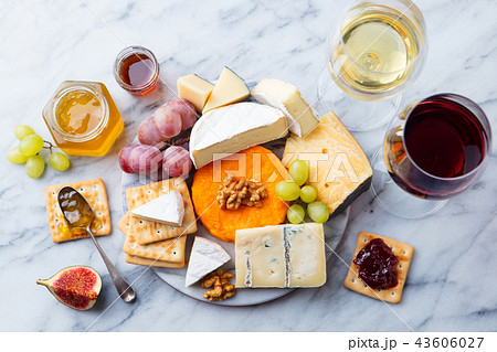 Assortment of cheese, grapes with red and white wine in glasses. Marble background. Top view. 43606027
