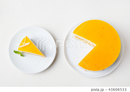 Passion fruit cake, mousse dessert on a white plate. Top view. Passion fruit cake, mousse dessert on a white plate. Top view. 43606533