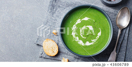 Broccoli, spinach cream soup in a bowl with toasted bread. Top view. Copy space. 43606789