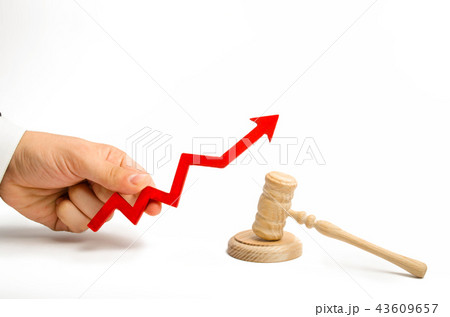 hand holds the arrow up near the judge's hammer hand holds the arrow up near the judge's hammer 43609657