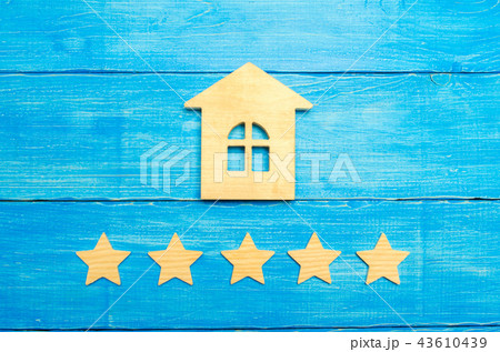 Wooden house and five stars on a gray background Wooden house and five stars on a gray background 43610439