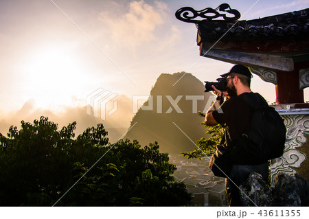 Photographer capturing sunrise over karst rocks in Yangshuo Chin 43611355