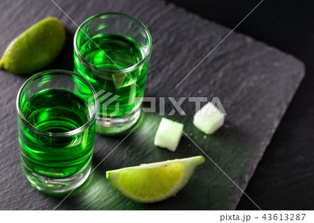 Two glasses of absinthe with lime slices and pieces of sugar Two glasses of absinthe with lime slices and pieces of sugar 43613287