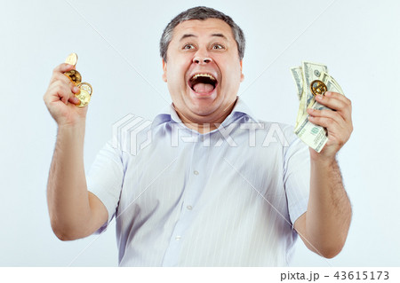 Man screams with delight from bitcoin and dollars, he won. Man screams with delight from bitcoin and dollars, he won. 43615173