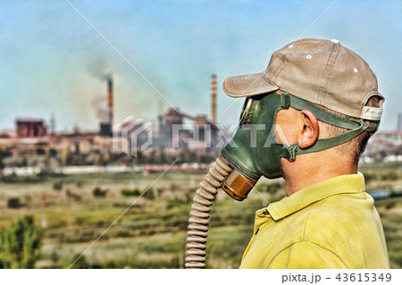 Men in gas mask against industrial smoking pipe. Men in gas mask against industrial smoking pipe. 43615349