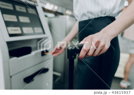 Woman is standing near ATM machine at airport Woman is standing near ATM machine at airport 43615937