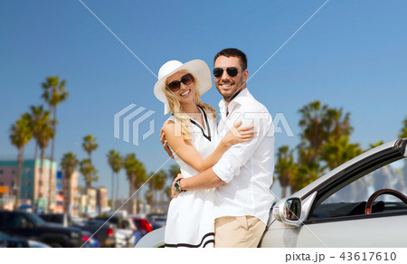 happy couple hugging near convertible car happy couple hugging near convertible car 43617610