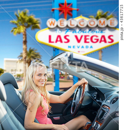 happy woman driving convertible car at las vegas 43617715