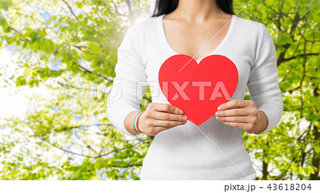 woman with gay awareness wristband holding heart 43618204