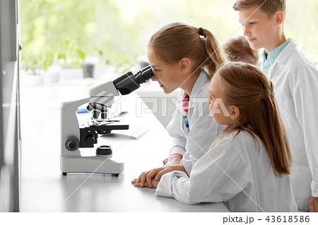 kids or students with microscope biology at school kids or students with microscope biology at school 43618586