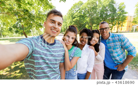 group of happy international friends taking selfie 43618690