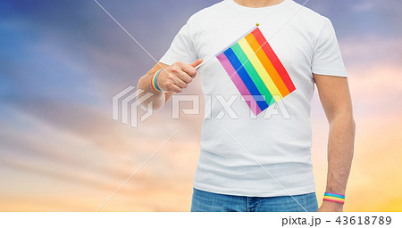 man with rainbow flag and gay pride wristbands man with rainbow flag and gay pride wristbands 43618789