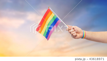 hand with gay pride rainbow flag and wristband 43618971