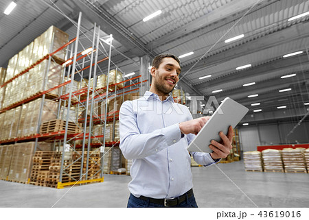 happy businessman with tablet pc at warehouse happy businessman with tablet pc at warehouse 43619016