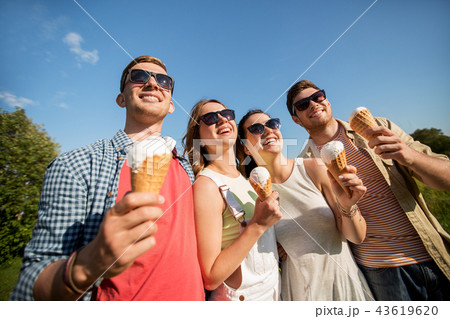 group of smiling friends with ice cream outdoors 43619620