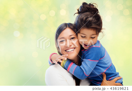 happy mother and daughter hugging over green 43619621